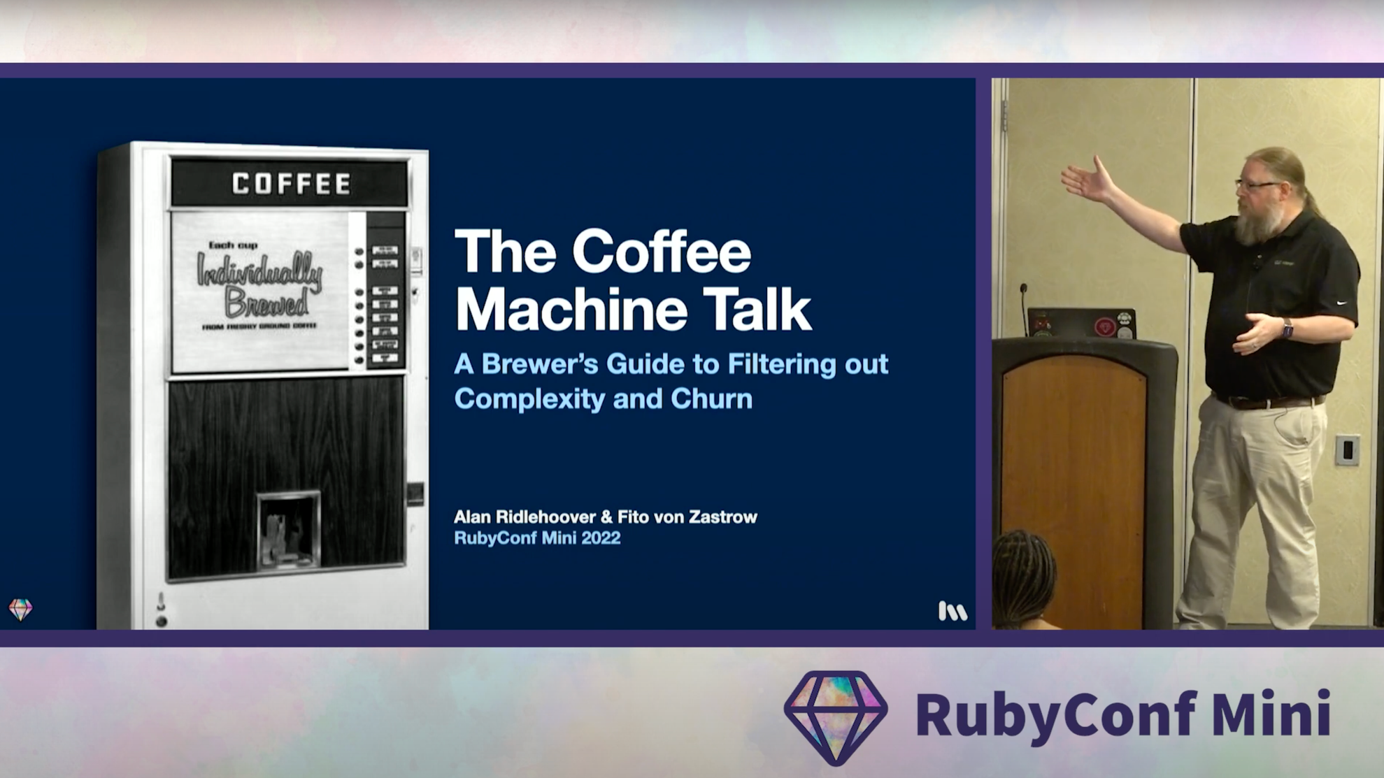 Alan Ridlehoover presenting (with Fito von Zastrow) at RubyConf Mini (in 2022), with a picture of a cartoon ruby on a large screen